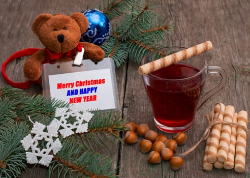 tea, baking, nutlets and a toy bear with a label, the subject Christmas and New Year
