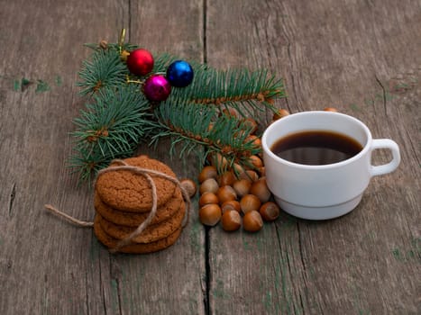 coffee, fir-tree branch, linking of oatmeal cookies and forest nutlets, subject holidays Christmas and New Year