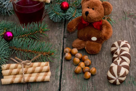coniferous branch, linking of cookies, tea and toy bear, still life subject Christmas and New Year