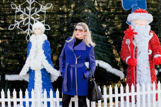 the beautiful woman between the Snow Maiden and Ded Moroz against a New Year tree, a subject the woman and holidays Christmas and New Year