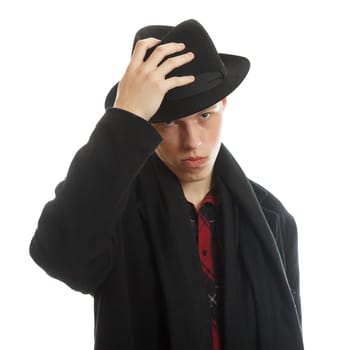 A young well drassed male tipping his hat