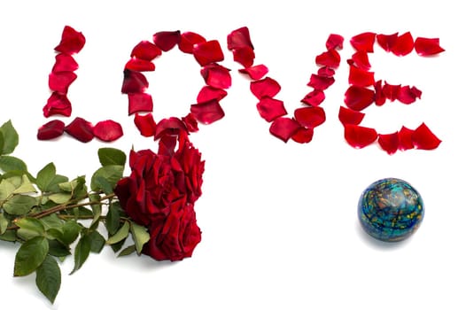 inscription Love from petals of roses and a bouquet of scarlet roses, globe, a subject abstraction flowers and love