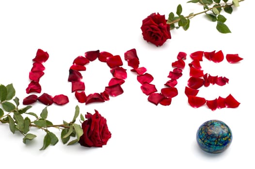 inscription Love from petals of roses and a rose from above and from below, a subject abstraction flowers and love