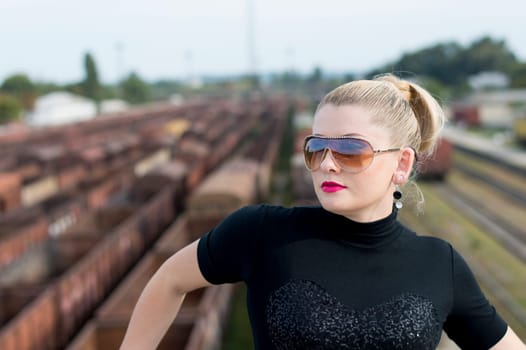 The woman's portrait on the bridge, over the railway station, a subject beautiful women and railway roads
