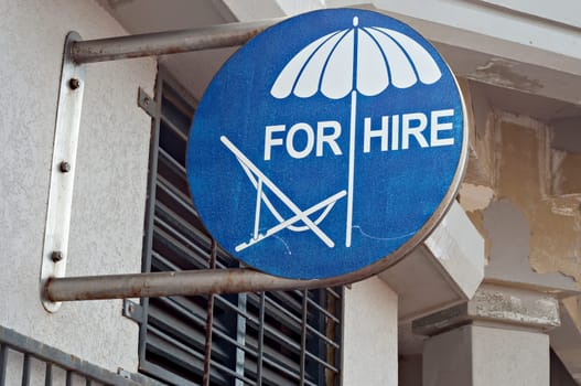Sign advertising beach chairs and umbrellas for hire