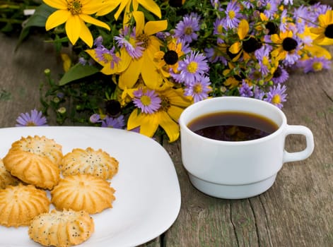 bouquet of wild flowers, coffee and plate with baking, a subject flowers and drinks