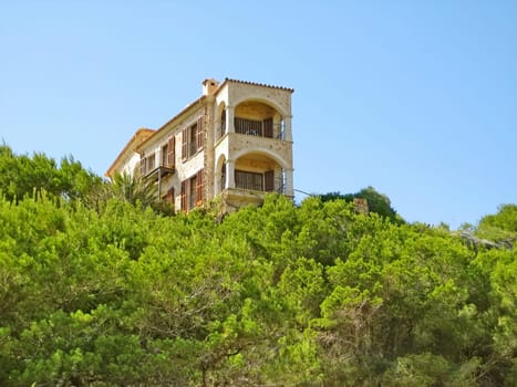 Apartment building / house, accommodation, view of balconies, green trees / bushes in front, blue sky