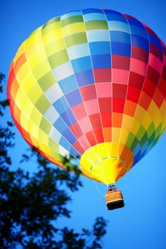 Raznouvetny balloon in clouds. Balloon in the sky. Flight by a balloon.