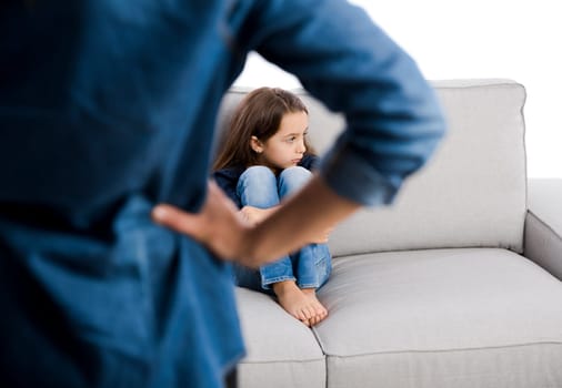 Grown up rebuking a little child for bad behavior