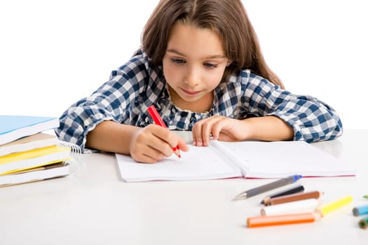Little girl at school making drawings and painting