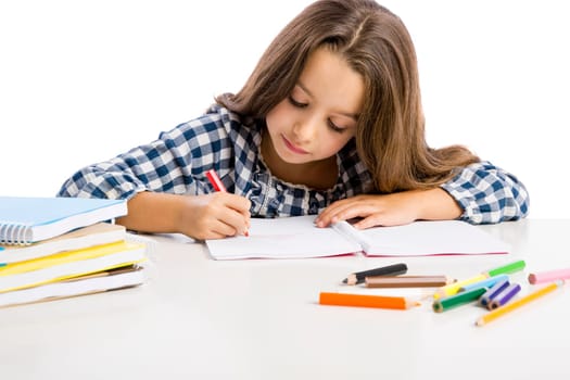Little girl at school making drawings and painting