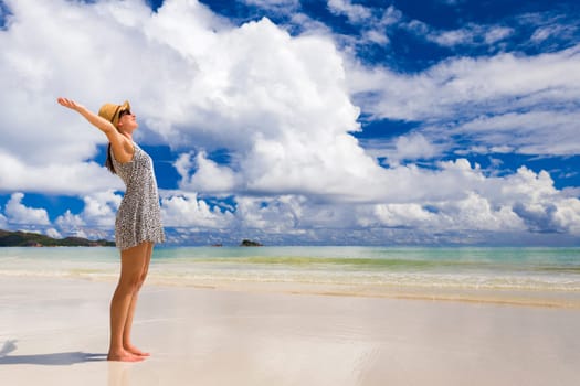 Beautiful woman walking in the beautiful beach of Praslin, Seychelles