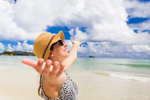 Beautiful woman walking in the beautiful beach of Praslin, Seychelles
