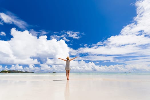 Beautiful woman walking in the beautiful beach of Praslin, Seychelles