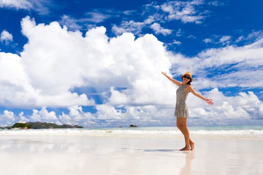 Beautiful woman walking in the beautiful beach of Praslin, Seychelles