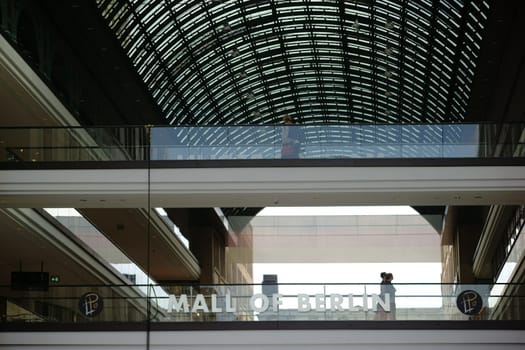Berlin,Germany - June 21,2016: Guests and visitors walk over two bridges with glass railings in the Mall of Berlin on June 21,2016 in Berlin.