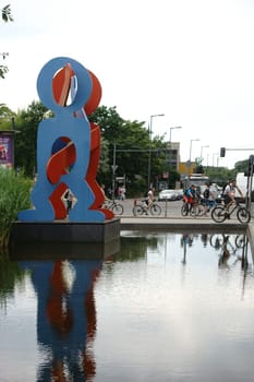 Berlin,Germany - June 21,2016: Cyclists and pedestrians pass the sculpture Untitled Boxers 1987 by Keith Haring on June 21,2016 in Berlin.