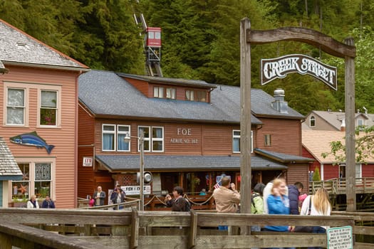 KETCHIKAN, ALASKA, USA - MAY 29, 2011: People Looking for Salmon and Photographing while Enjoying Visit of Creek Street in Ketchikan Alaska.