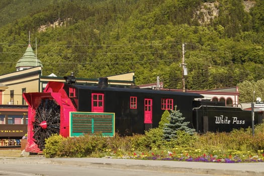 SKAGWAY, ALASKA, USA - JULY 12, 2011: Old Snow Blower Train and Trees in the Background