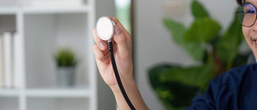 A focused medical student holds a stethoscope, symbolizing readiness and commitment to the healthcare profession.