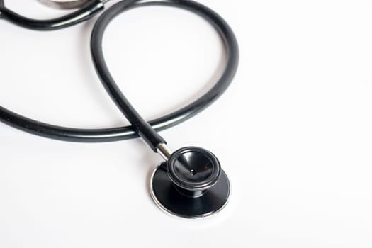 Black stethoscope on white background, stock photo