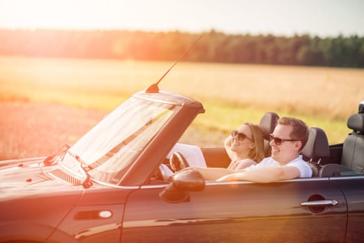Couples in the car in the sunshine