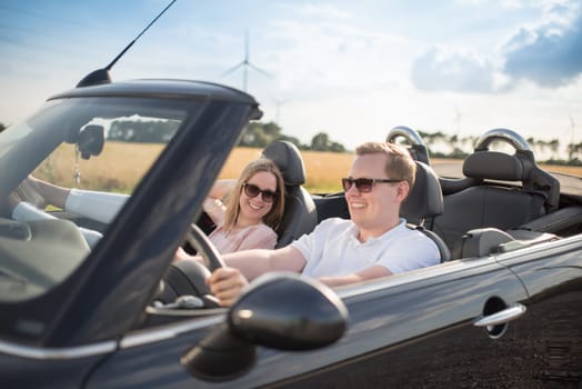Young lovers in convertibles on the road