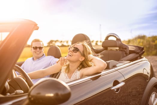 Couple in love in a convertible goes on holiday and is happy