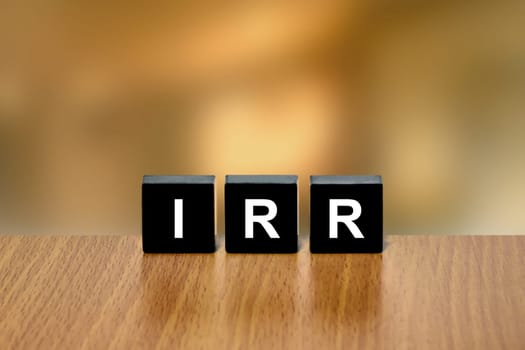 IRR or Internal Rate Of Return on black block with blurred background