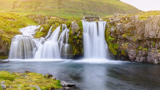 Beautiful waterfall landscape at Kirkjufell mountain, Snaefellsnes peninsula, Iceland, with soft light effect