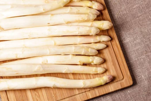 Delicate organic white asparagus ready to be peeled before they can be steamed