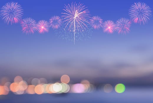 Firework on blurred twilight sky background with colorful city lights bokeh on a shore