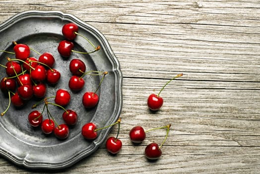 Fresh cherries on wooden table close up