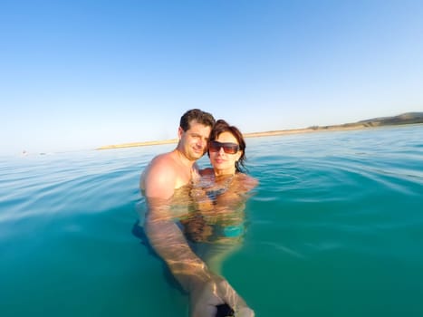 Couple having fun in the water summertime holidays
