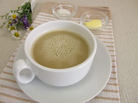A cup of butter coffee - black coffee with butter and coconut oil for breakfast
