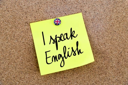 Yellow paper note pinned on cork board with Great Britain flag thumbtack, written text I Speak English, British Business concept