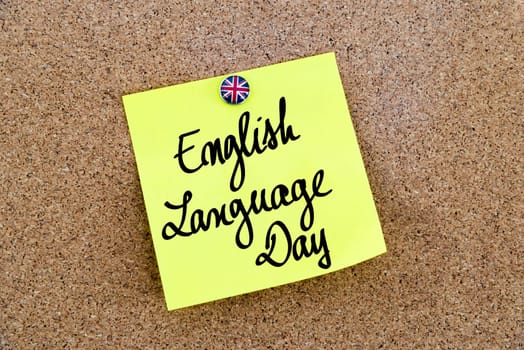 Yellow paper note pinned on cork board with Great Britain flag thumbtack, written text English Language Day, British Business concept