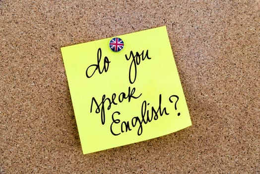 Yellow paper note pinned on cork board with Great Britain flag thumbtack, written text Do You Speak English ?, British Business concept