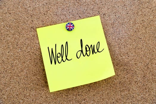 Yellow paper note pinned on cork board with Great Britain flag thumbtack, written text Well Done, British Business concept