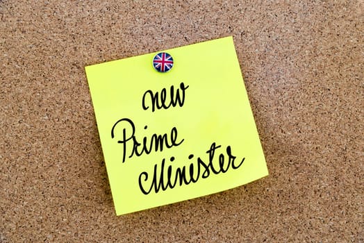 Yellow paper note pinned on cork board with Great Britain flag thumbtack, written text New Prime Minister, British Business concept