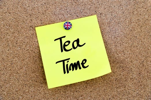 Yellow paper note pinned on cork board with Great Britain flag thumbtack, written text TEA TIME, British Business concept