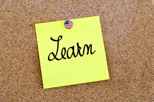 Written text Learn over yellow paper note pinned on cork board