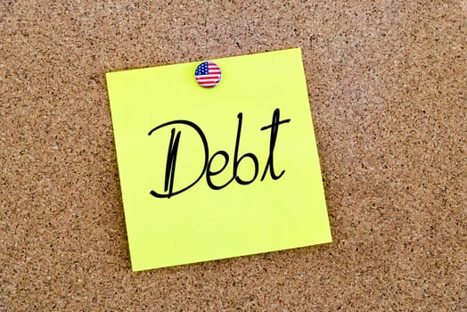 Written text Debt over yellow paper note pinned on cork board