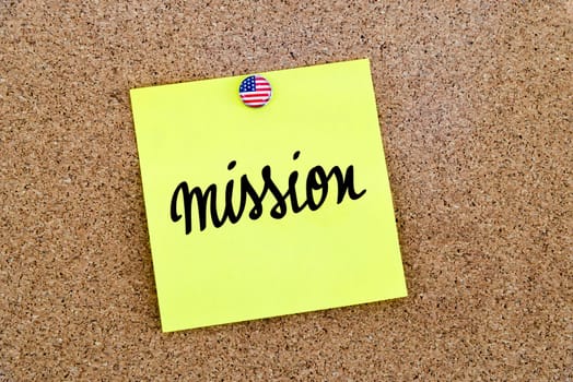 Written text Mission over yellow paper note pinned on cork board