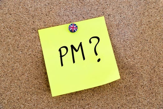 Yellow paper note pinned on cork board with Great Britain flag thumbtack, written text PM as Prime Minister, British Business concept