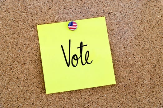Written text Vote over yellow paper note pinned on cork board