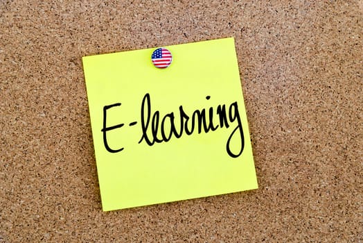 Written text E-Learning over yellow paper note pinned on cork board