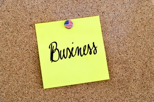 Written text Business over yellow paper note pinned on cork board