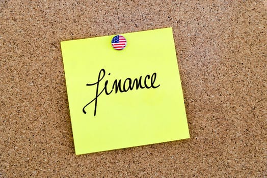 Written text Finance over yellow paper note pinned on cork board