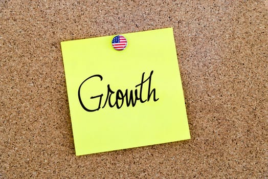 Written text Growth over yellow paper note pinned on cork board